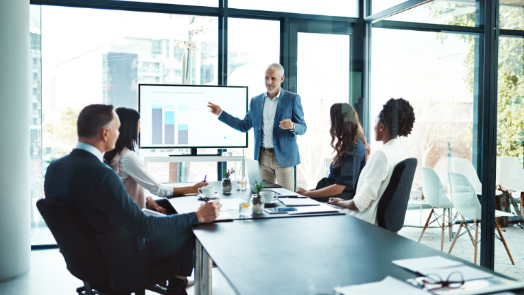 Businessman giving a presentation in a boardroom.